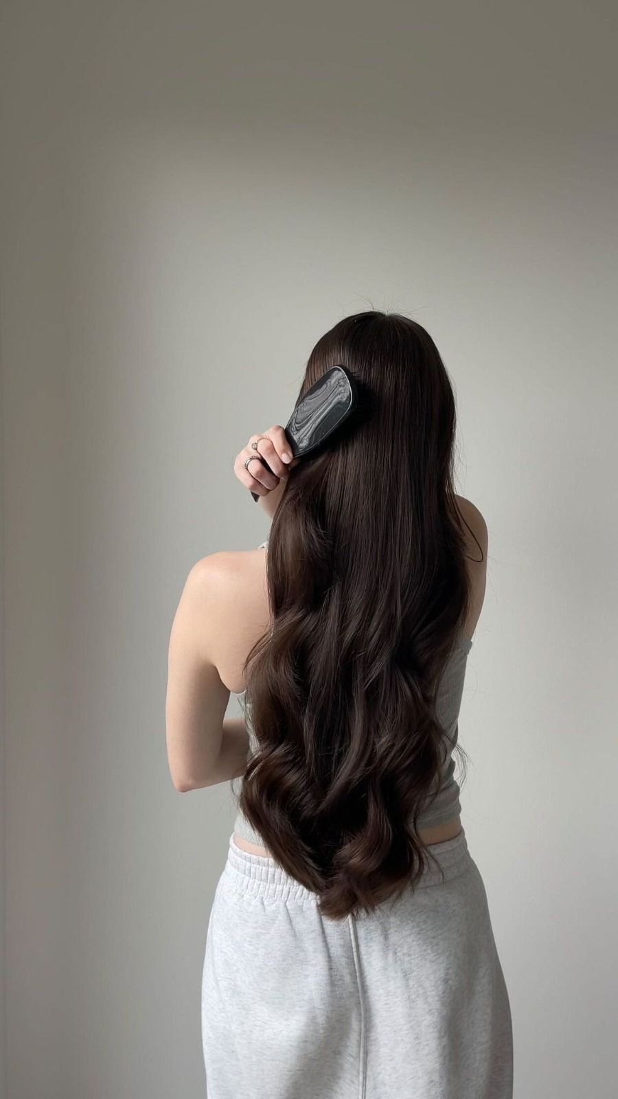 Woman combing her thick healthy hair