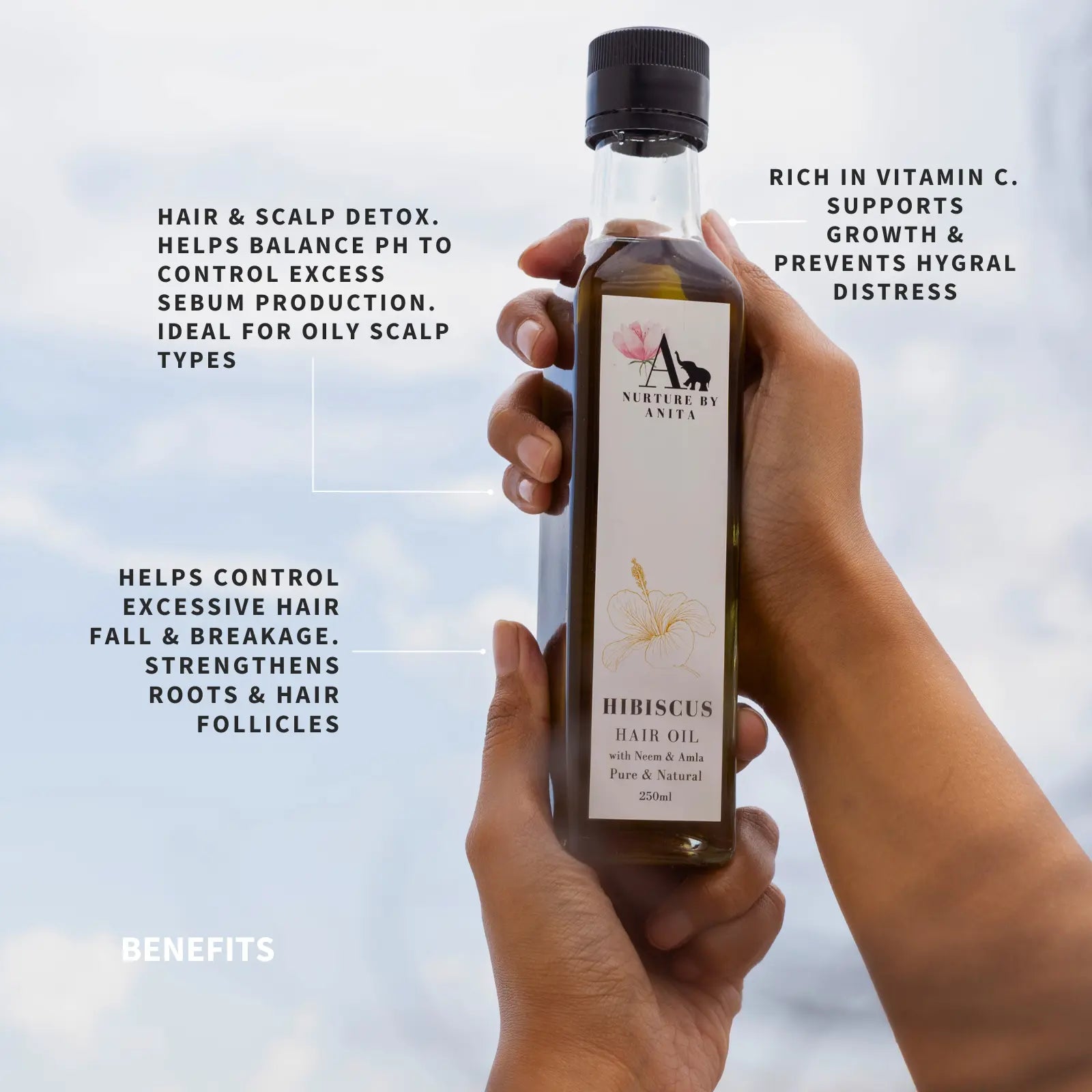 Nurture by Anita Hibiscus Hair Oil in a glass bottle, surrounded by fresh hibiscus flowers, neem leaves, and amla, highlighting its organic, in-house farmed ingredients for healthy, shiny hair